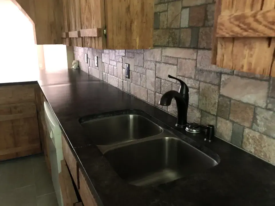 Long stretch of kitchen counter space with wood cabinets