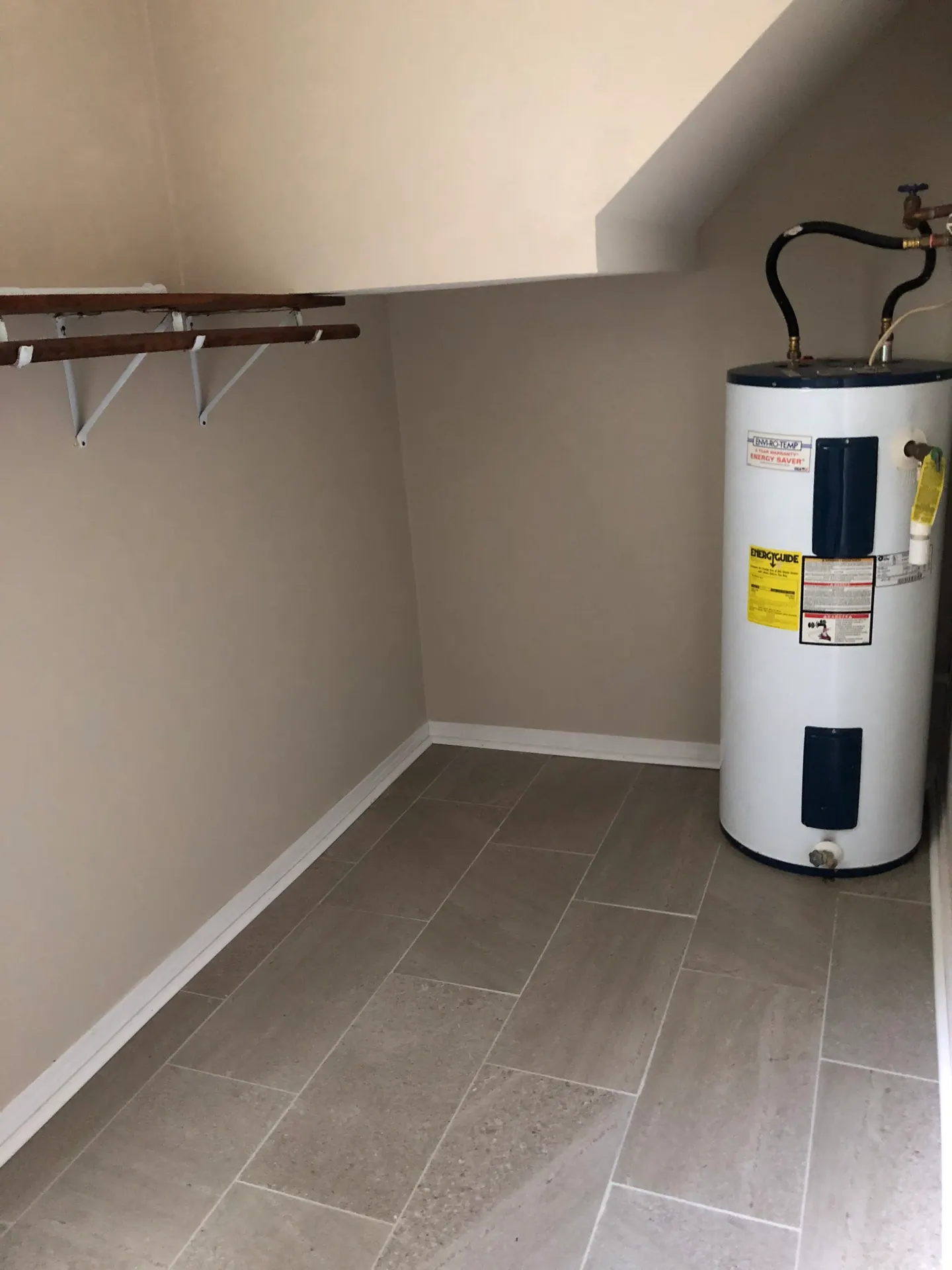 Utility side of the large laundry room, with shelving and water heater